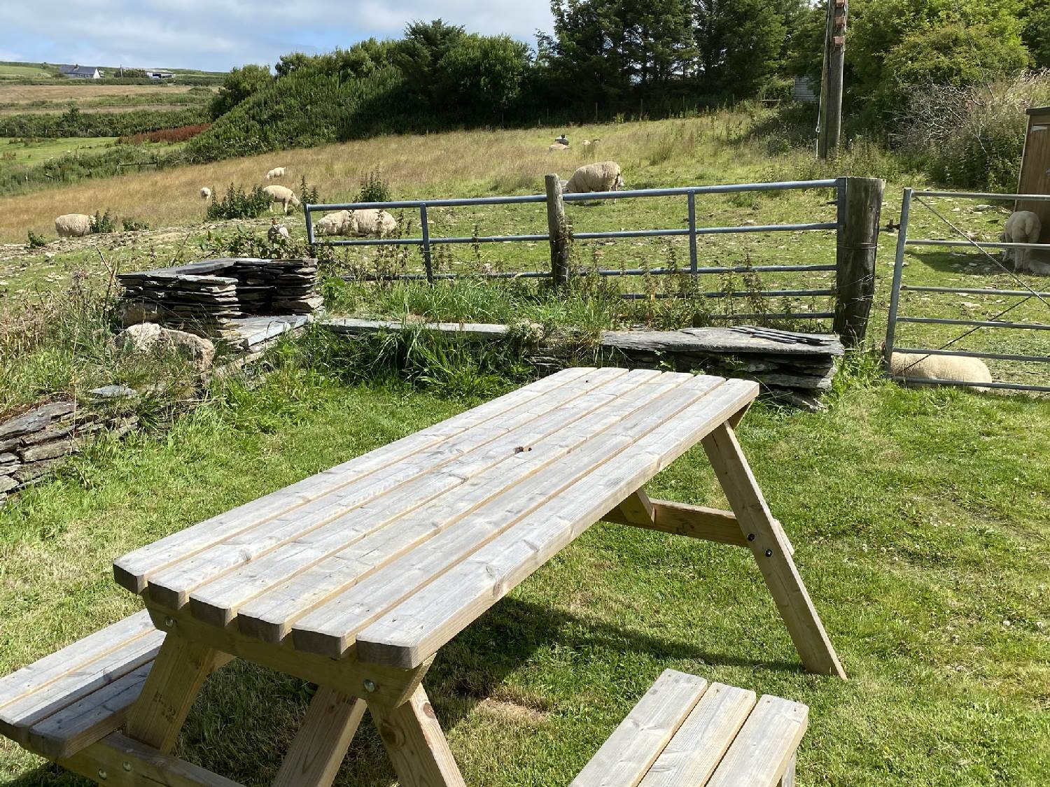BBQ and seating in the sea view breakfast garden at Polrunny Farm Holiday Cottages, Cornwall