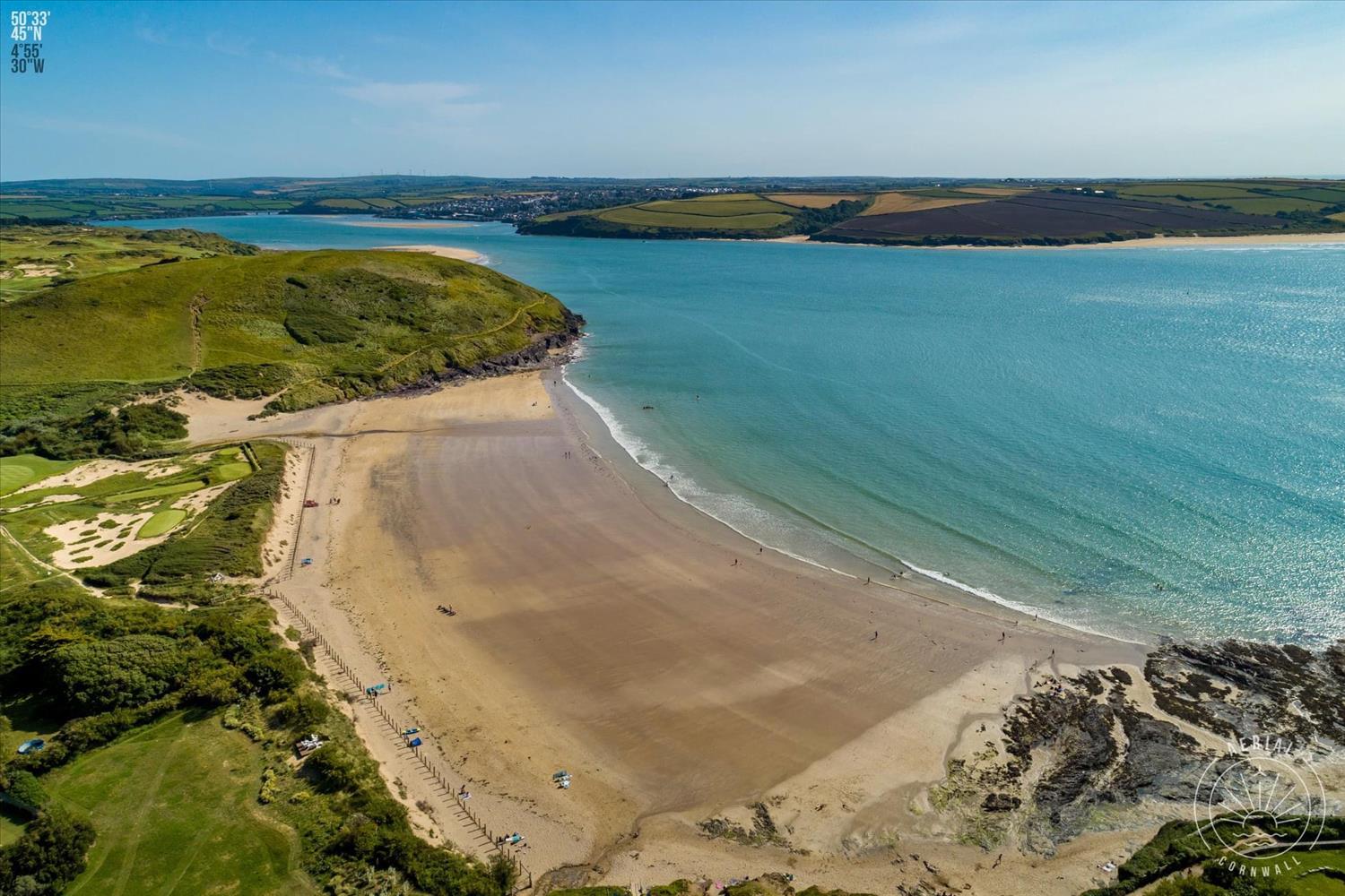 Daymer Bay, a sheltered sandy beach at the head of the Camel Estuary where the Camel River meets the Atlantic. Thie beach is deserted in this photo, but in the summer, families with young children love playing in these shallow waters