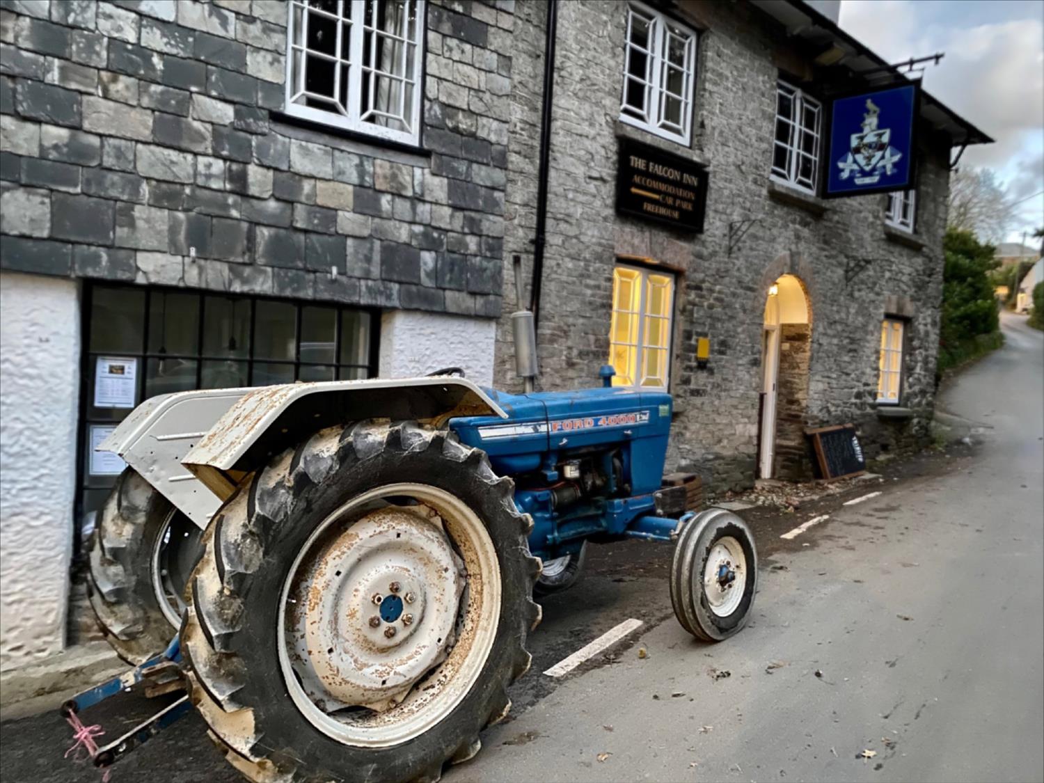 A tractor parked outside The Falcon Inn, St Mawgan, North Cornwall