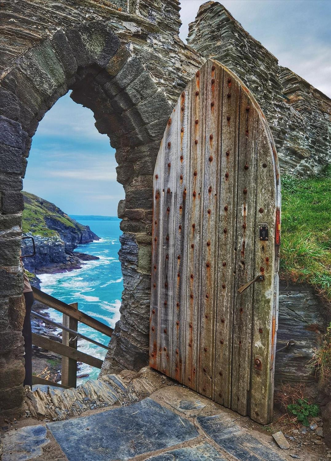 Dramatic view of the sea through an ancient Moon Gate at Tintagel castle, a five mile walk along the coast from Boscastle