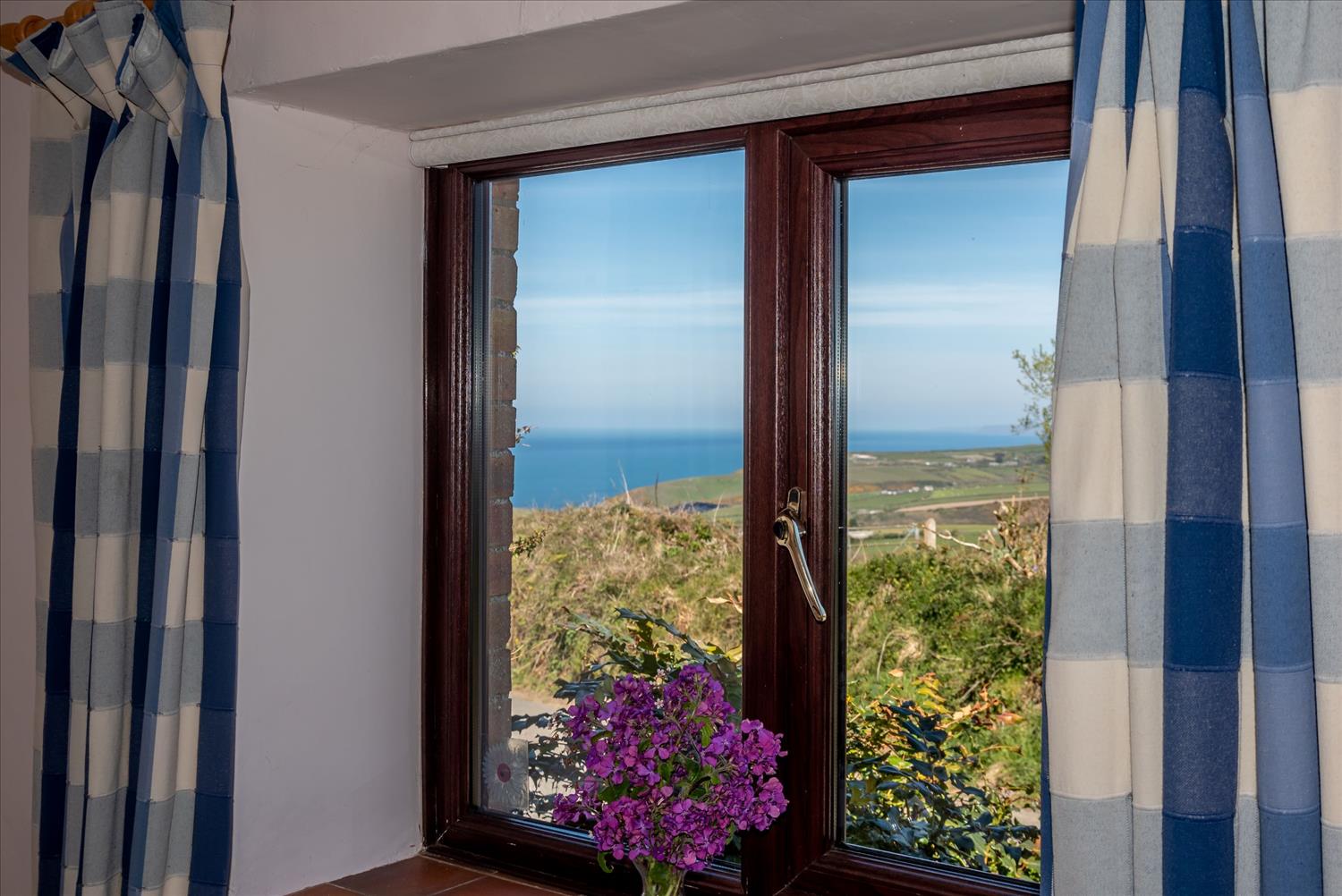 Sea view from the double bedroom at Seaberry, one of our traditional barn conversion cottages at Polrunny Farm