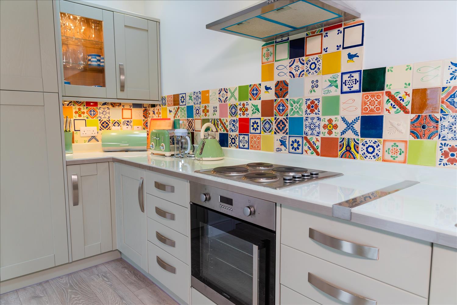 Sloe Cottage's modern fitted kitchen, with bright Mexican-style tiles attracting the eye