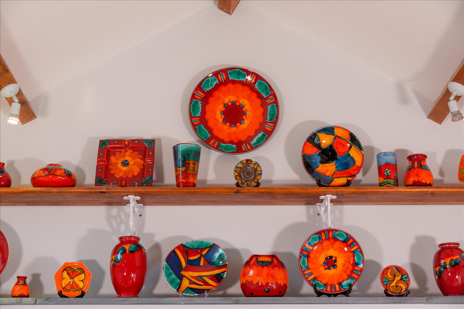 Sloe Cottage's collection of bright-coloured pottery plates, vases and dishes