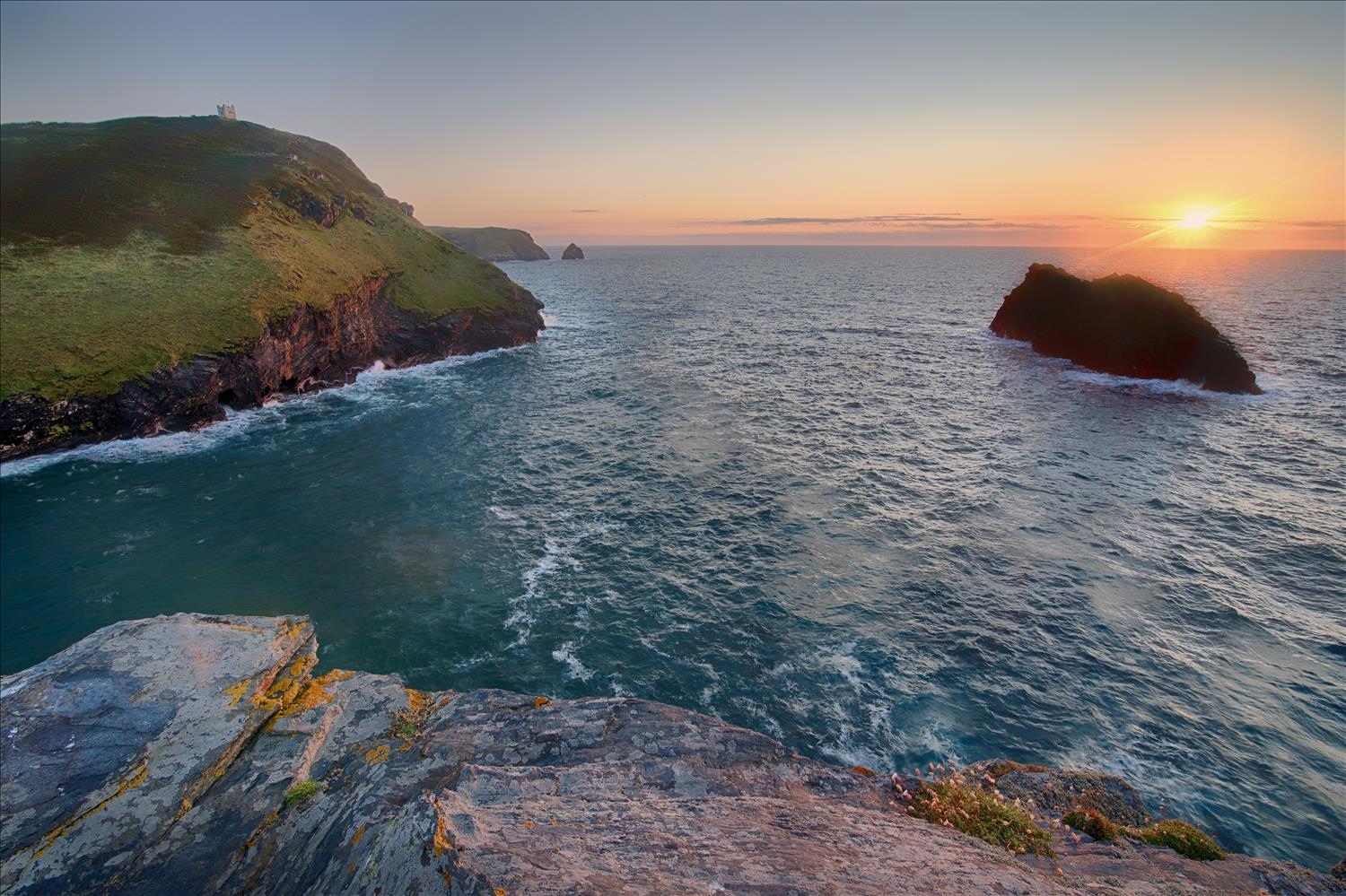 The entrance to Boscastle harbour as the sun sets over the Atlantic.