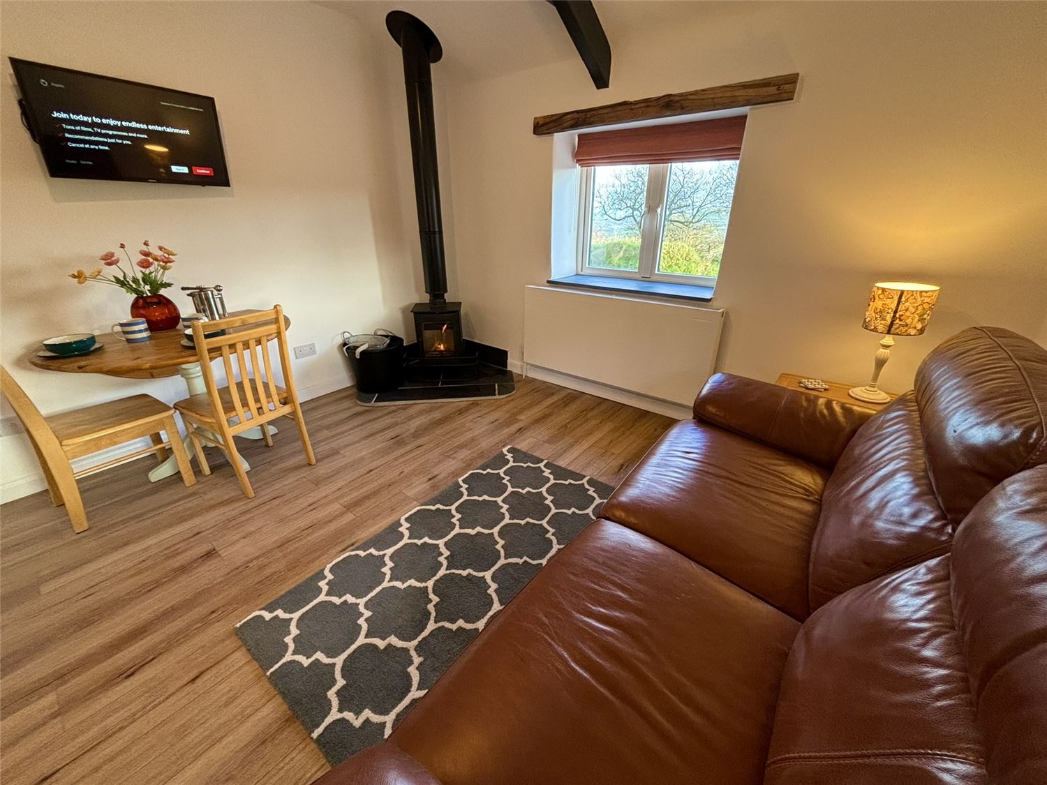 The cosy lounge at Seaberry Cottage. Watch your smart TV, or gaze at the sea view whilst the log burner keeps you cosy